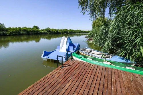 Elkerített vízpart stéggel, csónakkal, túrakenuval és vízibiciklivel