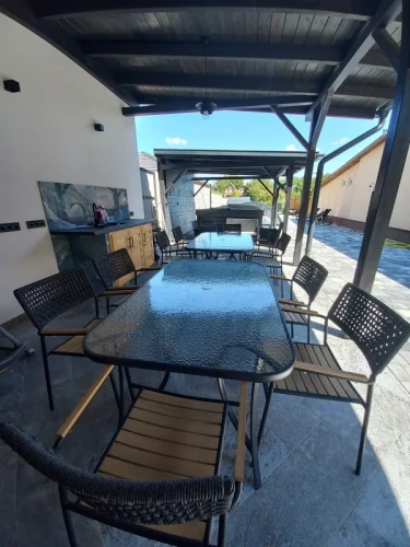 Fedett terasz alatt nyári konyha, étkezőasztalok, kilátással a jacuzzira, medencére